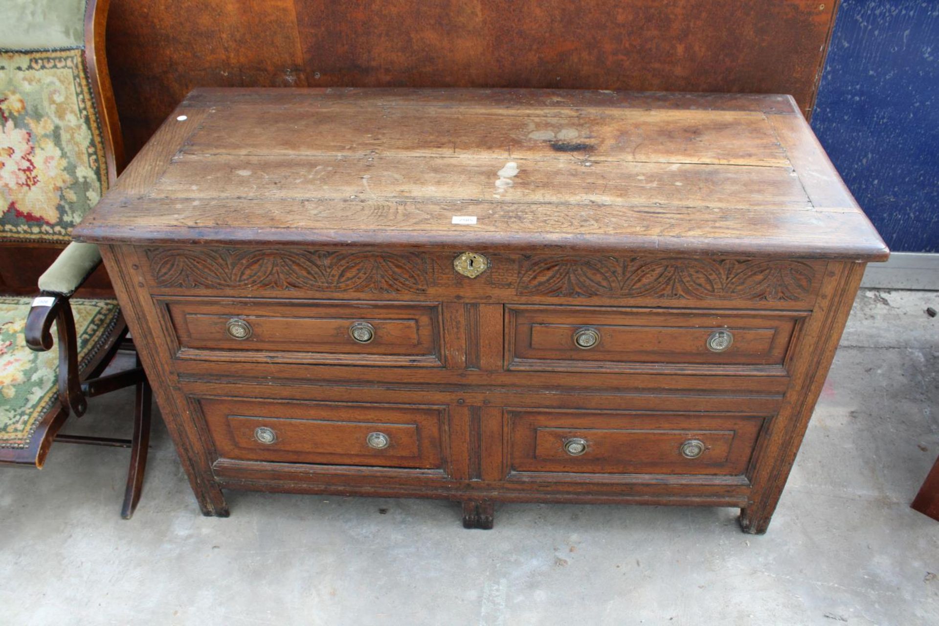 A GEORGE III OAK BLANKET CHEST WITH CARVED FRIEZE AND 4 SHAM DRAWERS, 52" WIDE