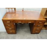 A MID 20TH CENTURY OAK TWIN PEDESTAL DESK ENCLOSING 8 DRAWERS, 54" X 27"