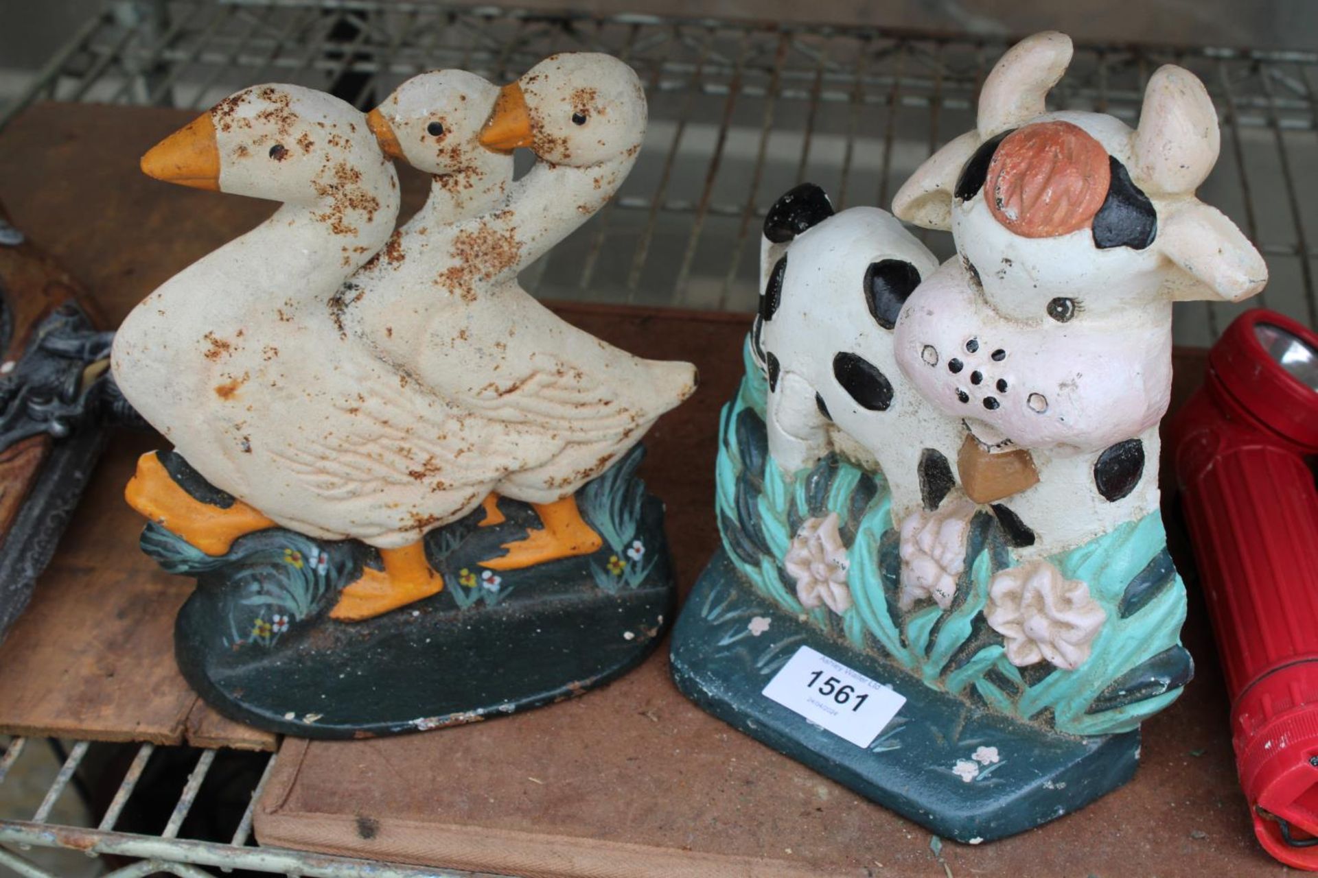 TWO VINTAGE CAST IRON ANIMAL DOOR STOPS TO INCLUDE A COW AND GEESE