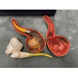 TWO MEERSCHAUM PIPES ONE WITH A CONTINENTAL SILVER COLLAR WITH CASE AND A FURTHER EXAMPLE