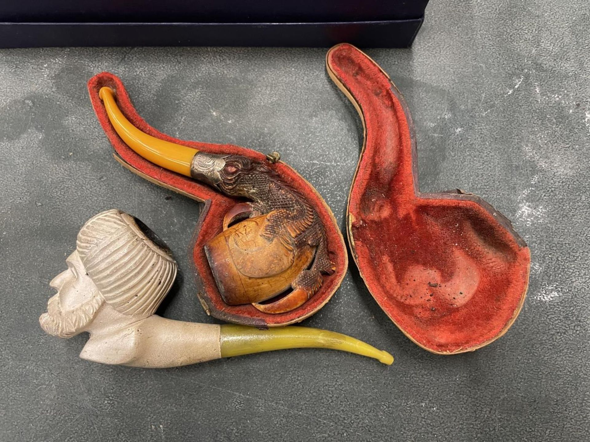 TWO MEERSCHAUM PIPES ONE WITH A CONTINENTAL SILVER COLLAR WITH CASE AND A FURTHER EXAMPLE