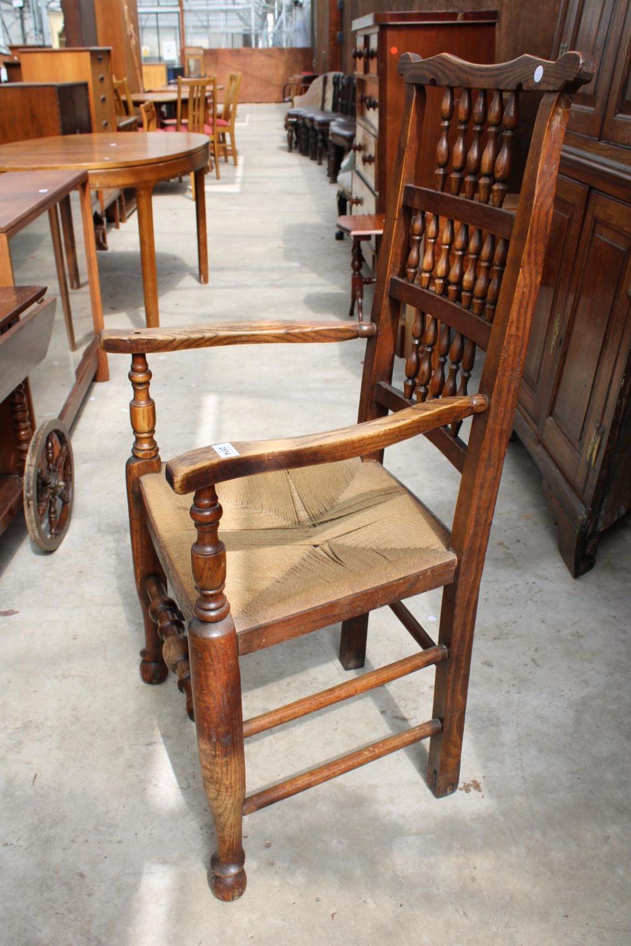 AN 18TH CENTURY STYLE ELM SPINDLE-BACK CARVER CHAIR WITH RUSH SEAT - Image 2 of 2