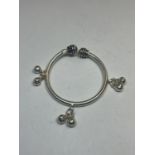 A BABY'S SILVER BANGLE WITH CHARMS