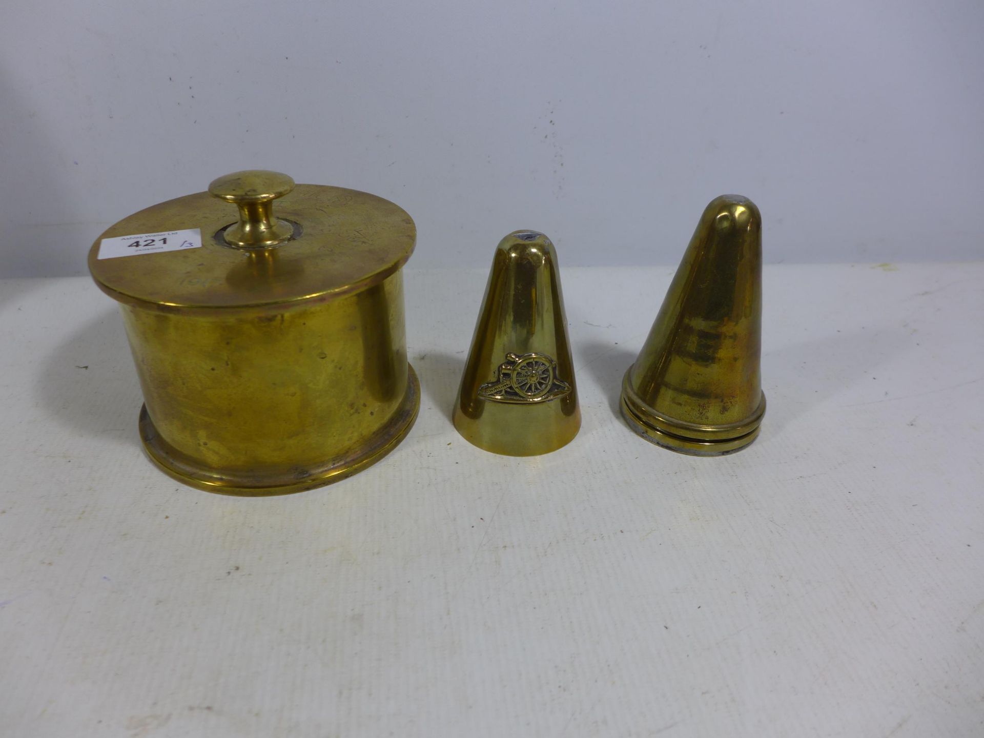 THREE BRASS WORLD WAR I TRENCH ART SHELL CASES IN THE FORM OF A BOX AND LIGHTER AND A LID, LIGHTER