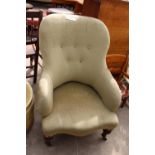 A VICTORIAN SPRUNG AND UPHOLSTERED LOUNGE CHAIR WITH BUTTON-BACK AND TURNED FRONT LEGS