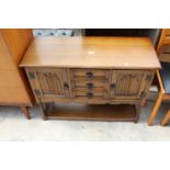 AN OAK JACOBEAN STYLE SIDE CABINET ENCLOSING 3 DRAWERS AND 2 CUPBOARDS WITH POT BOARD TO BASE ON