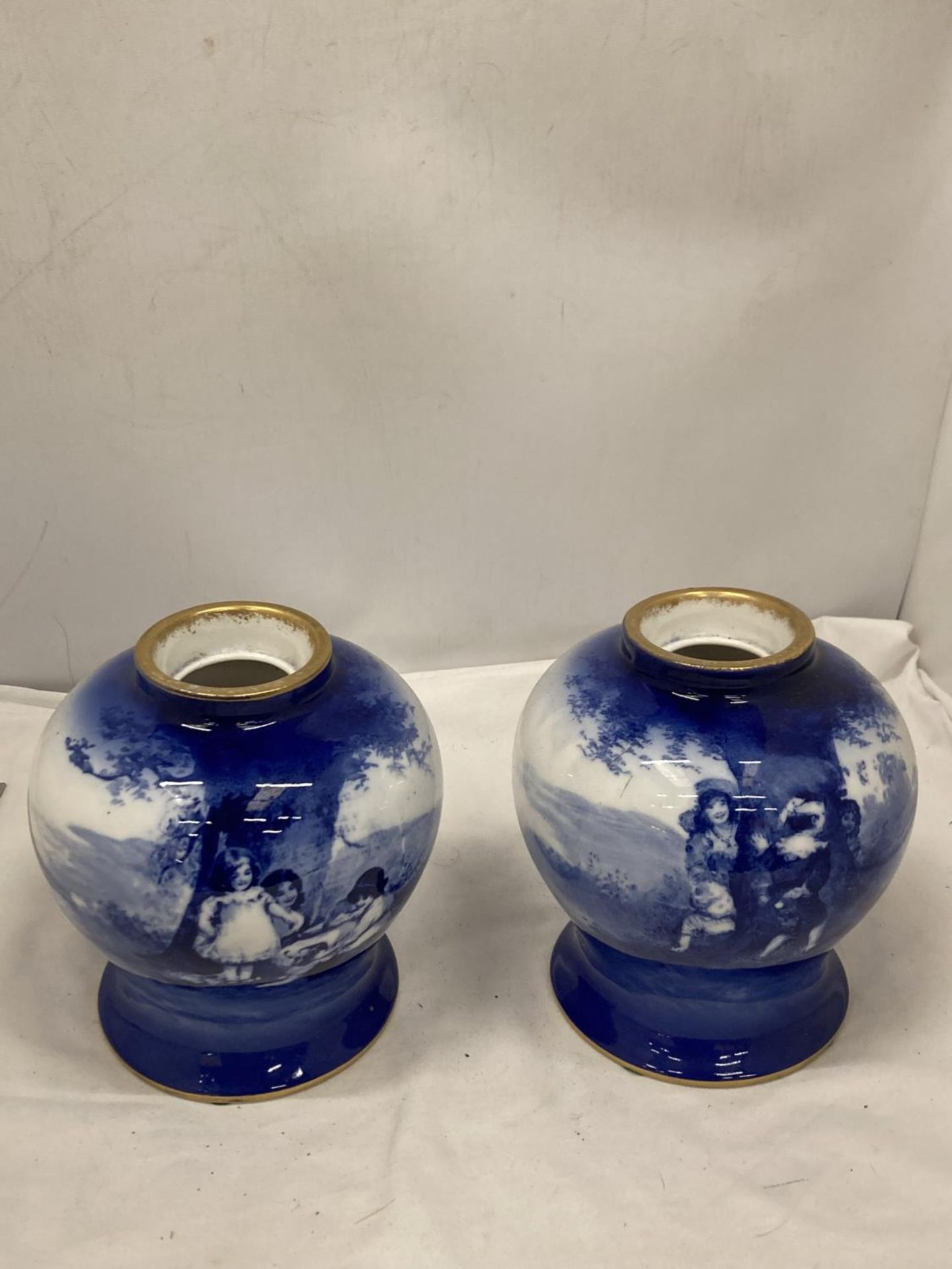 A PAIR OF ROYAL DOULTON BLUE CHILDREN SERIES VASES HEIGHT 17.5 CM