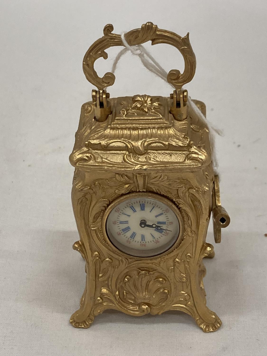 A MINIATURE GILDED FRENCH CLOCK WITH KEY HEIGHT 3.5" SEEN WORKING BUT NO WARRANTY