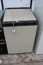 A BROWN AND CREAM HOTPOINT UNDER COUNTER FREEZER