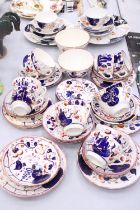 A LARGE QUANTITY OF VINTAGE GAUDY WELSH TEAWARE TO INCLUDE CAKE PLATES, SUGAR BOWLS, CUPS, SAUCERS