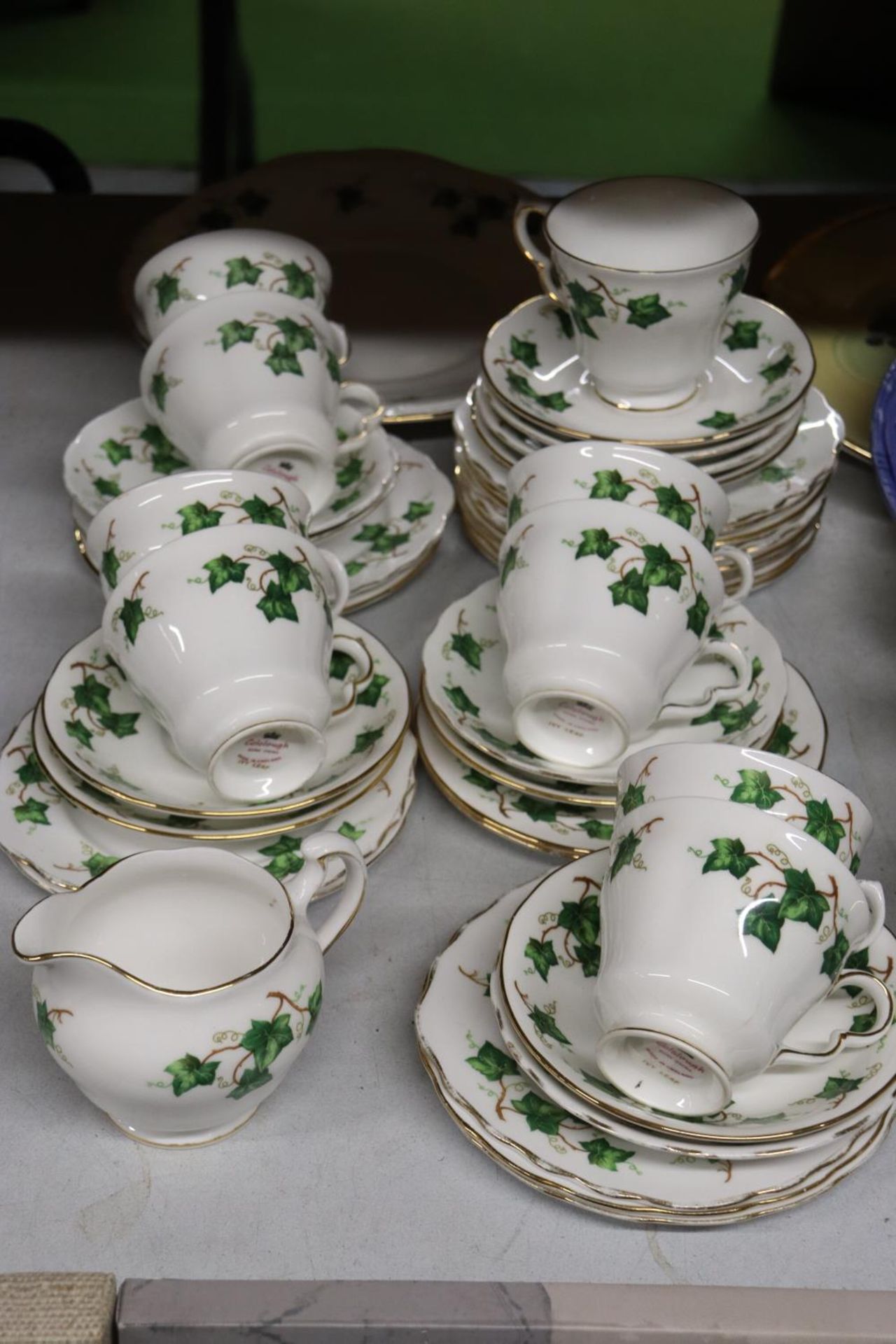 A COLCLOUGH 'IVY LEAF' PART TEASET TO INCLUDE CAKE PLATES, A CREAM JUG, CUPS, SAUCERS AND SIDE