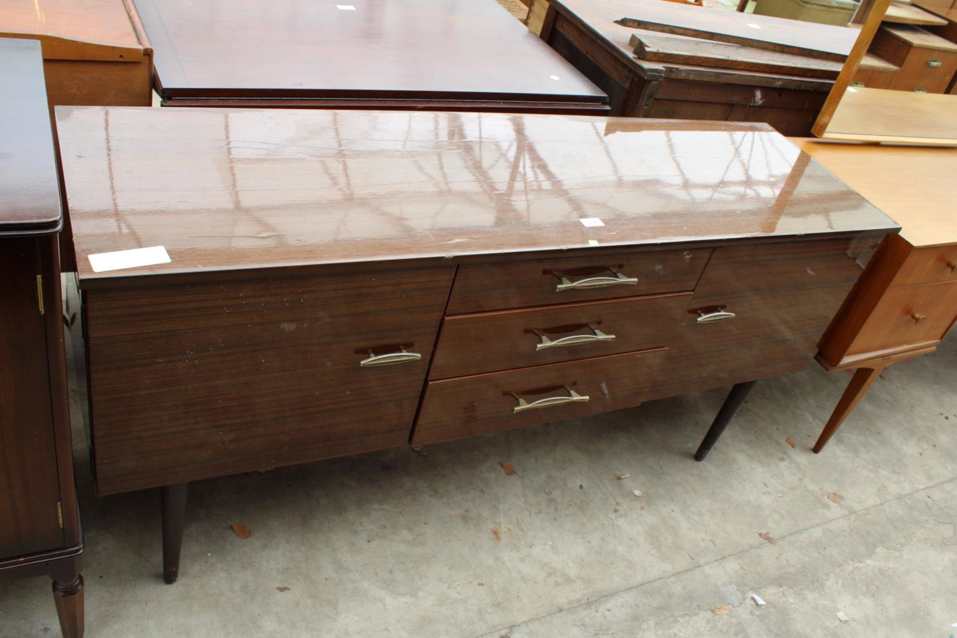 A RETRO SCHREIBER SIDEBOARD ENCLOSING THREE DRAWERS AND TWO CUPBOARDS, 59" WIDE