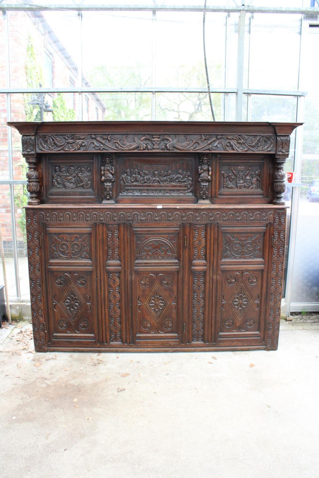 AN OAK GEORGE III STYLE COURT CUPBOARD WITH CARVED PANELS, THREE DEPICTING THE BIRTH AND