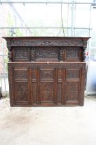 AN OAK GEORGE III STYLE COURT CUPBOARD WITH CARVED PANELS, THREE DEPICTING THE BIRTH AND