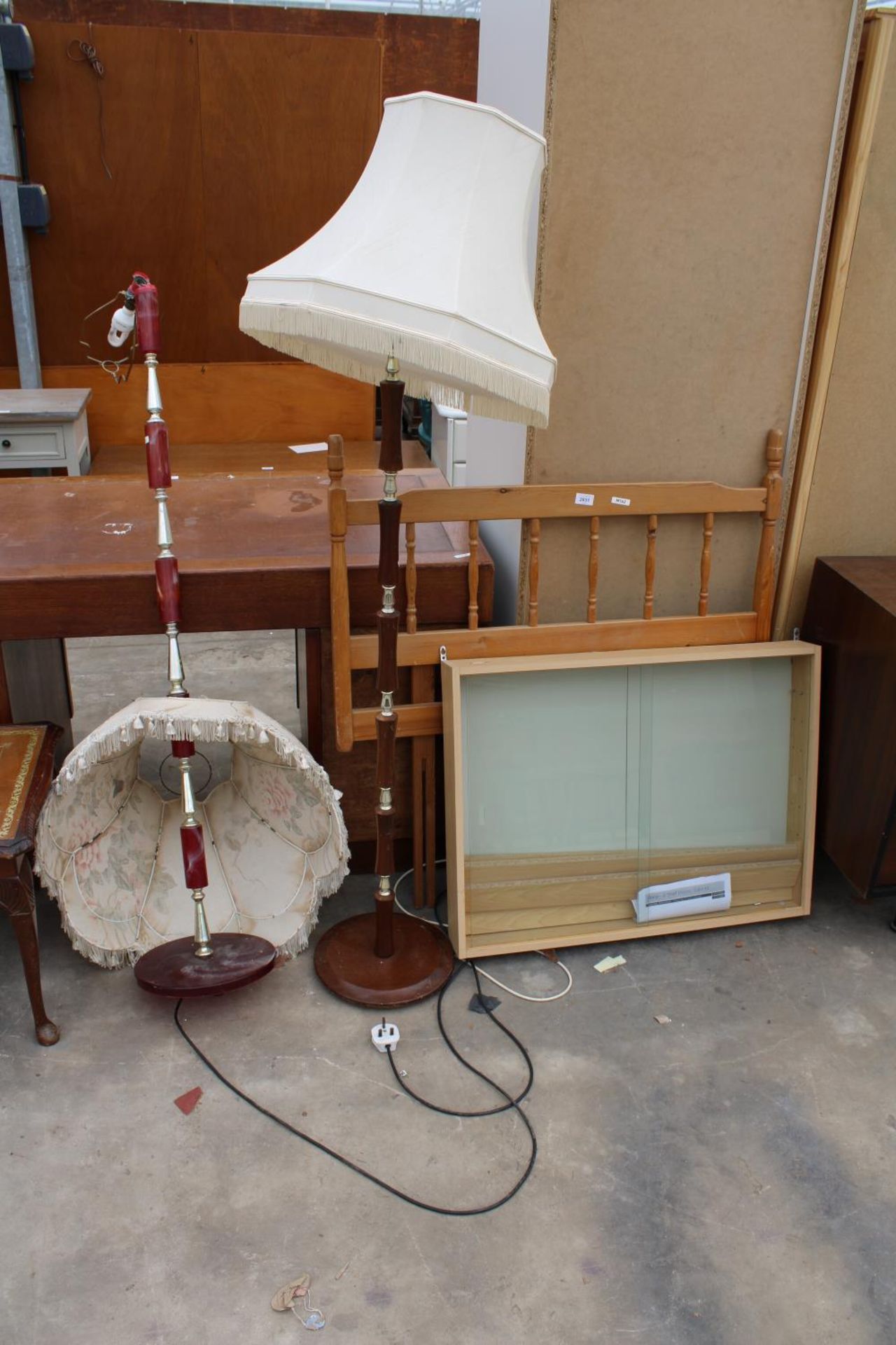 A PINE SINGLE HEADBOARD, TWO STANDARD LAMPS AND A DISPLAY CASE
