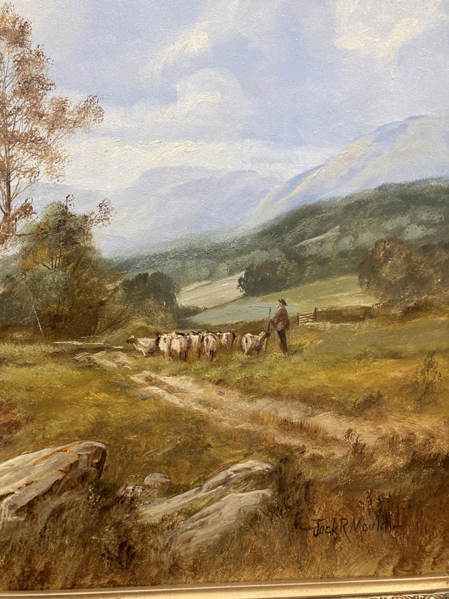 A GILT FRAMED OIL ON CANVAS OF A LAKE SCENE WITH A FARMER MOVING STOCK ...