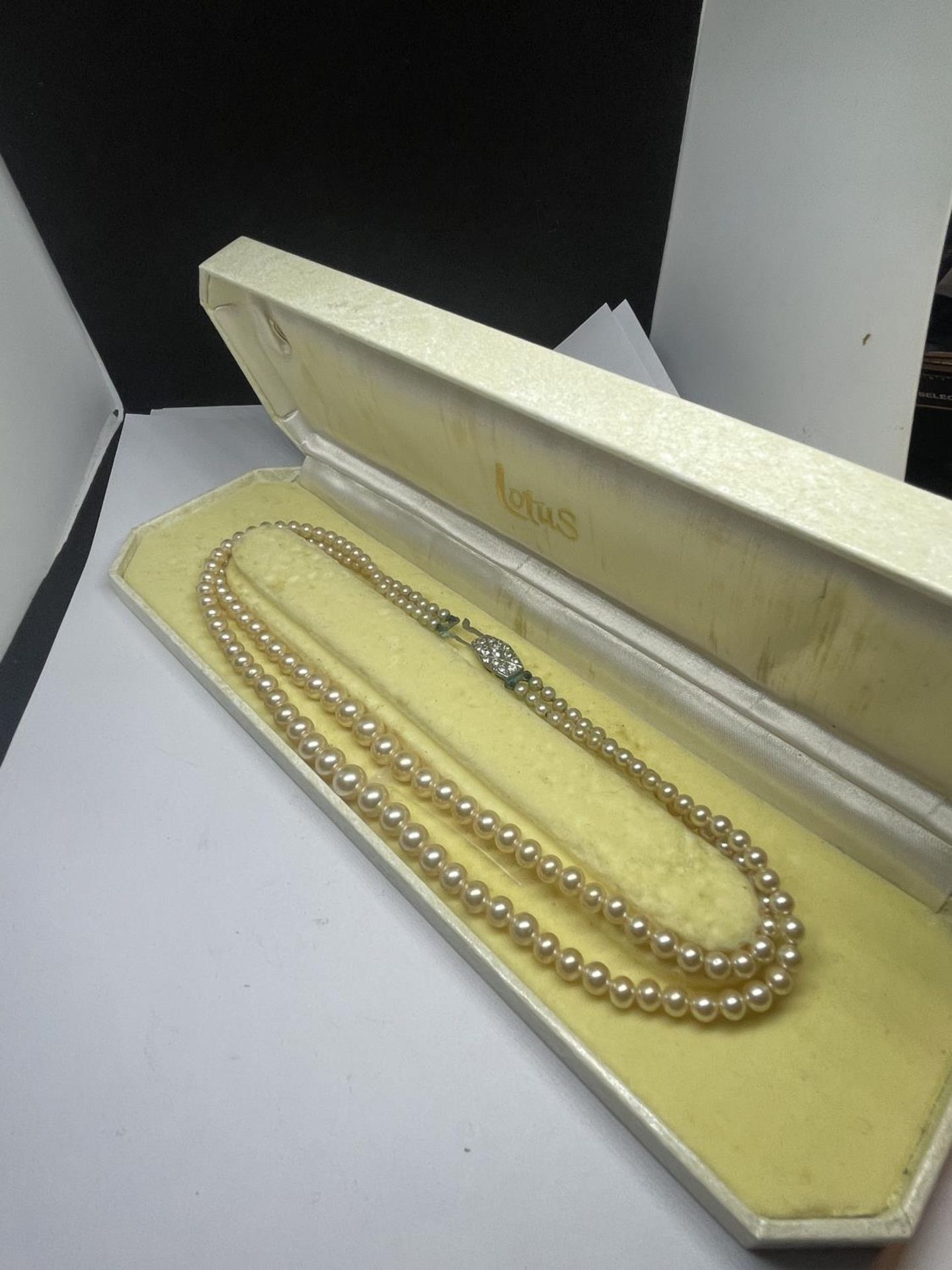 A SET OF LOTUS DOUBLE STRAND PEARLS IN A PRESENTATION BOX