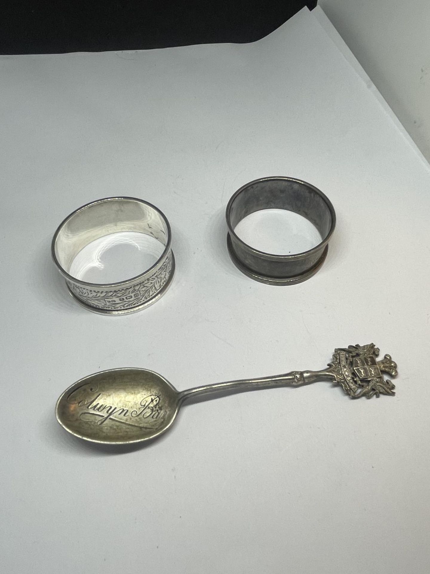 TWO HALLMARKED SILVER NAPKIN RINGS ONE BIRMINGHAM AND ONE LONDON AND A BIRMINGHAM SILVER SPOON