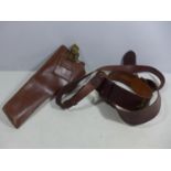 A MILITARY BROWN LEATHER GUN HOLSTER AND LEATHER SAM BROWNE BELT
