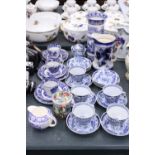 A LARGE QUANTITY OF ORIENTAL STYLE BLUE AND WHITE TO INCLUDE CUPS,SAUCERS,SIDE PLATES PLUS A JUG AND