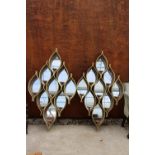 A PAIR OF MODERN PIERCED METALWARE MIRRORED RAINDROP MIRRORS WITH CANDLE HOLDERS