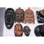 FIVE AFRICAN HAND CARVED WOODEN MASKS - PLUS TWO SPEARS