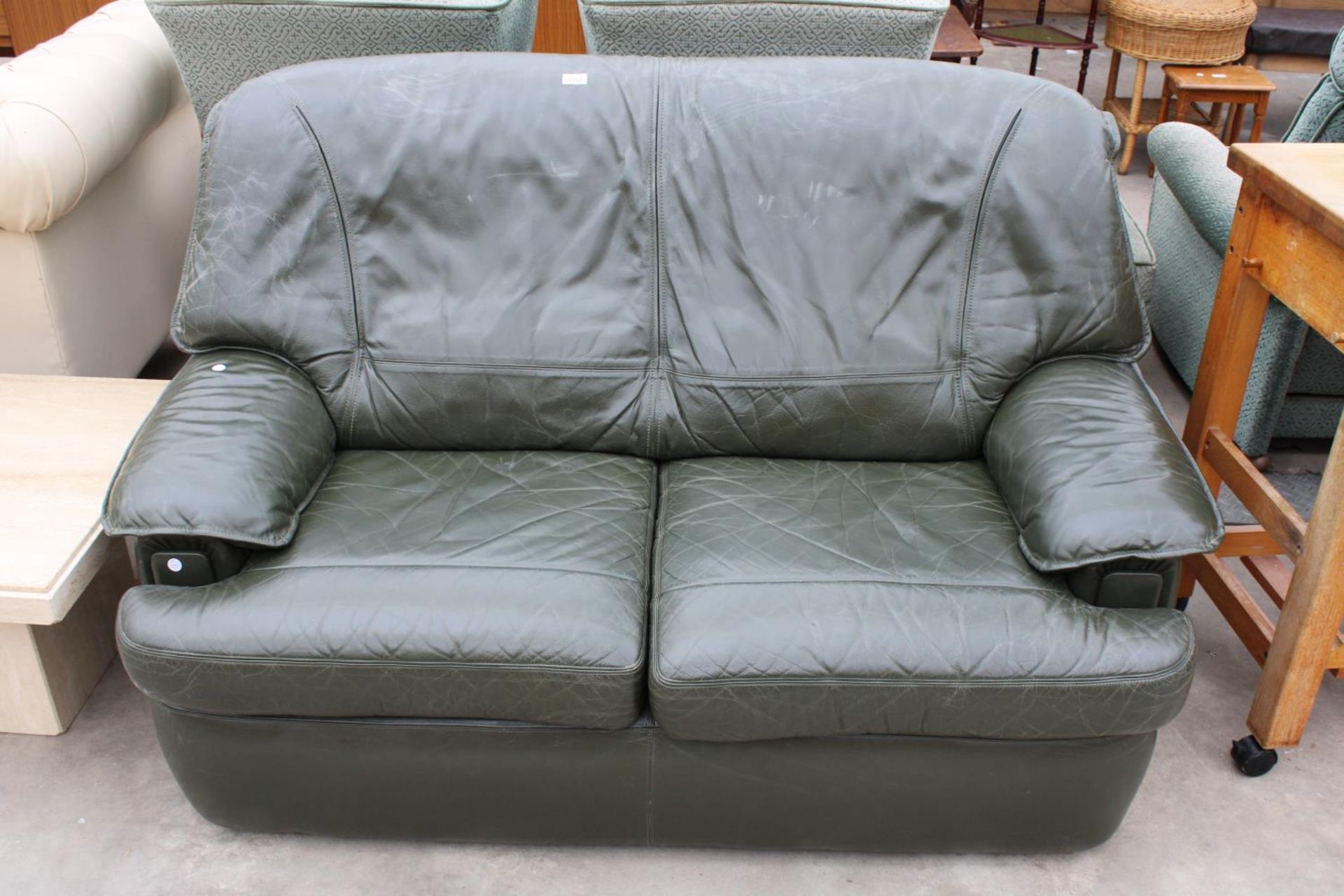 A MODERN GREEN LEATHER TWO SEATER SETTEE