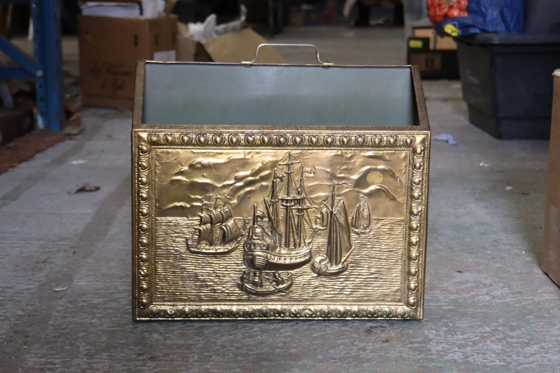A VINTAGE BRASS MAGAZINE RACK WITH GALLEONS IMAGE