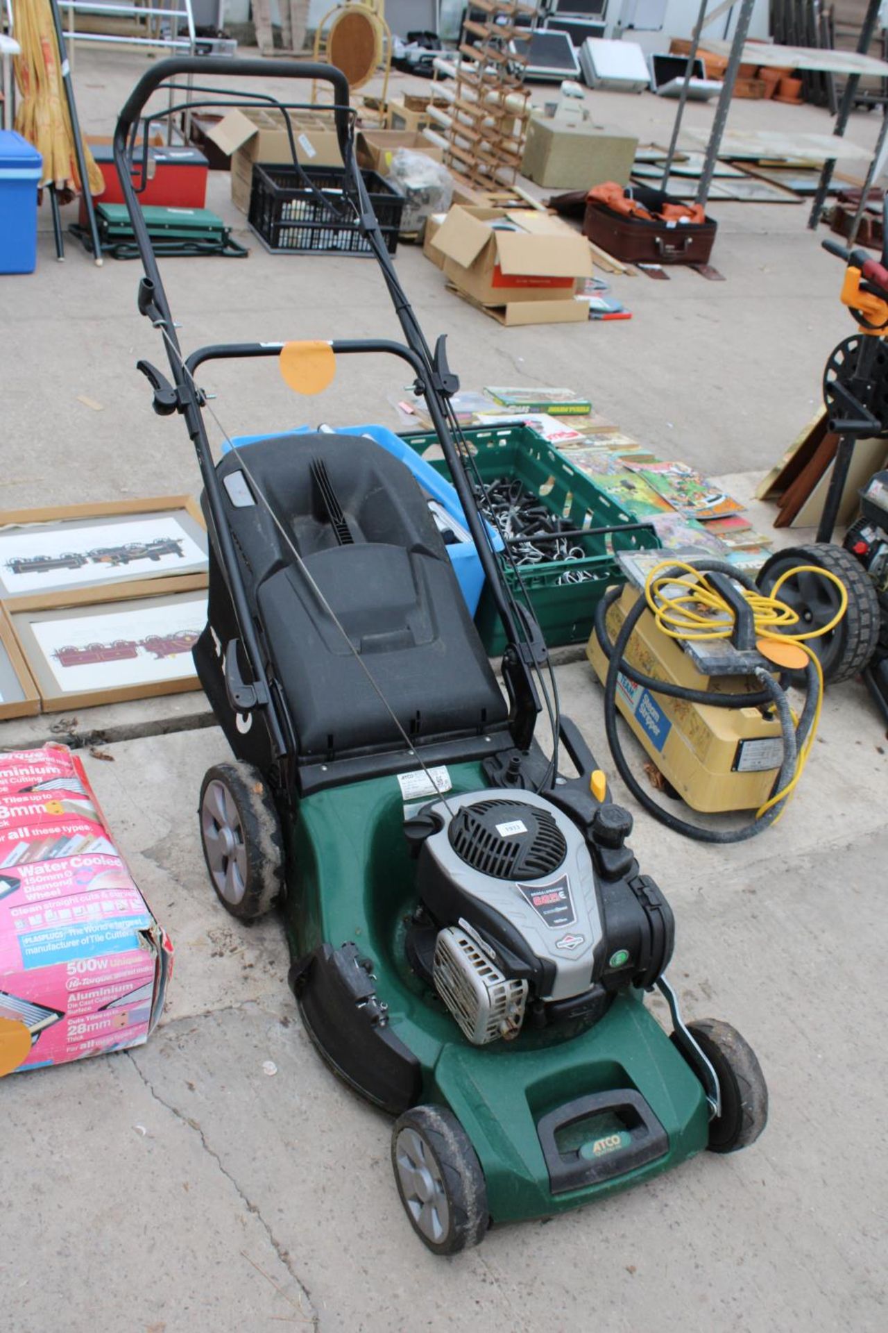 AN ATCO PETROL LAWN MOWER WITH GRASS BOX AND BRIGGS AND STRATTON ENGINE