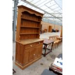 A MODERN PINE DRESSER WITH TWO DRAWERS AND CUPBOARD TO BASE AND PLATE RACK, 50" WIDE