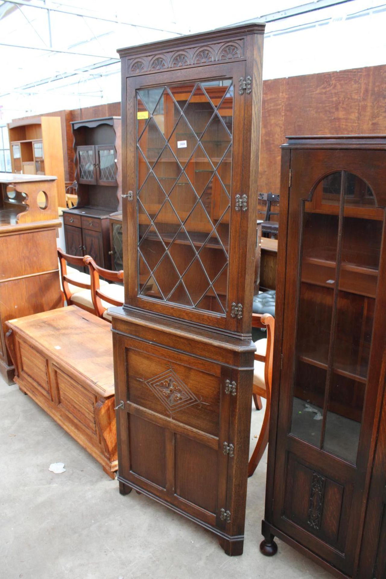 A MODERN OAK CORNER CUPBOARD WITH GLAZED AND LEADED UPPER PORTION