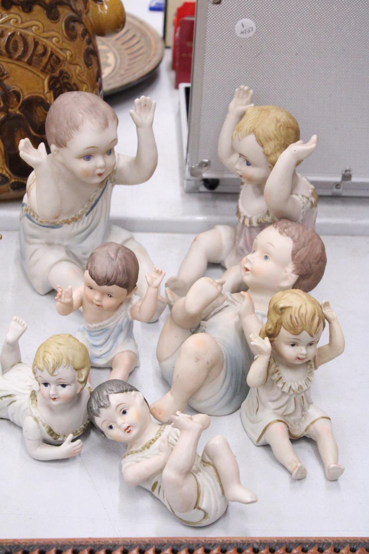 THREE LARGE AND FOUR SMALL ANTIQUE PORCELAIN, BISQUE DOLLS