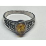 A SILVER AND AMBER RING