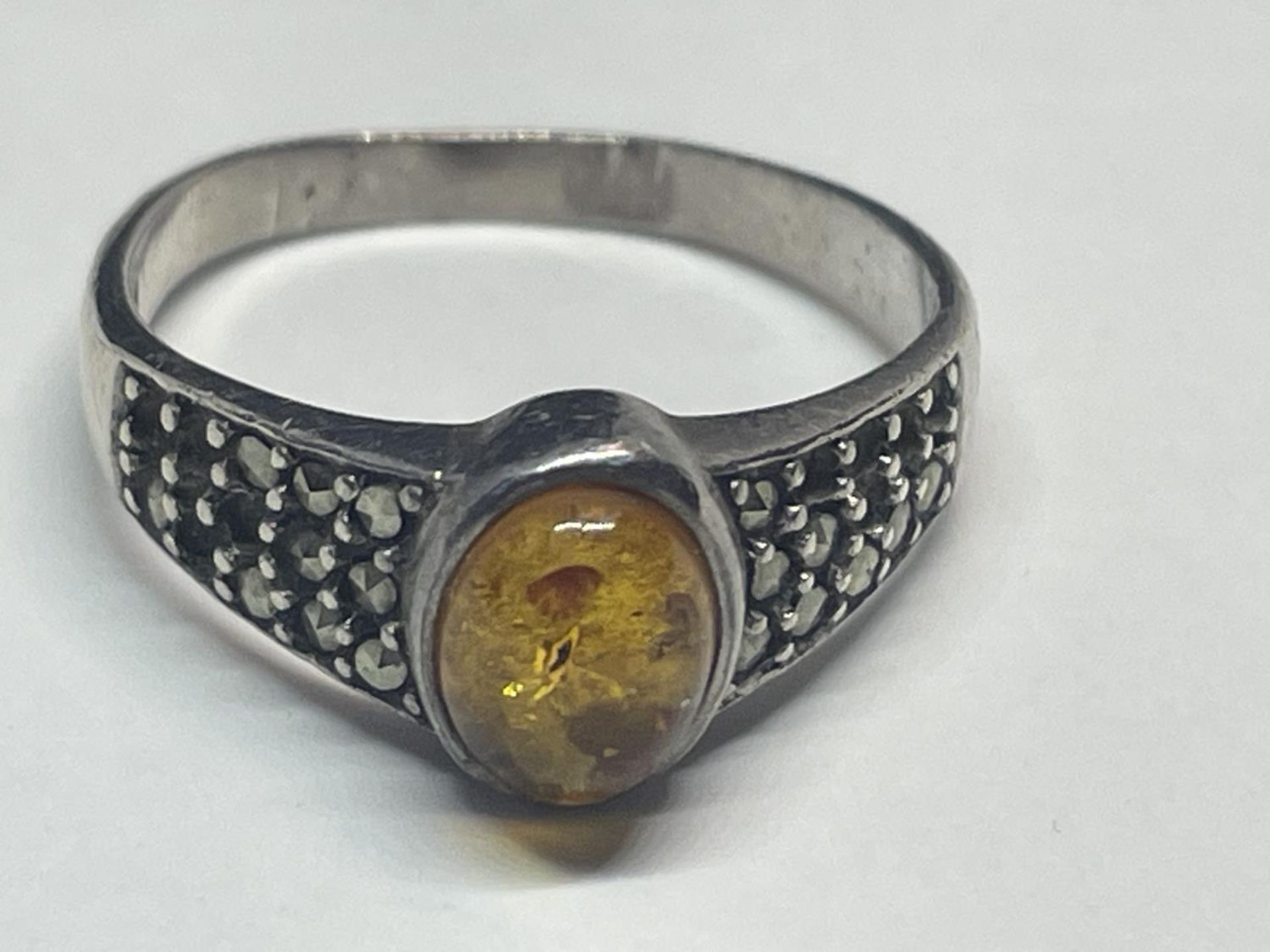 A SILVER AND AMBER RING
