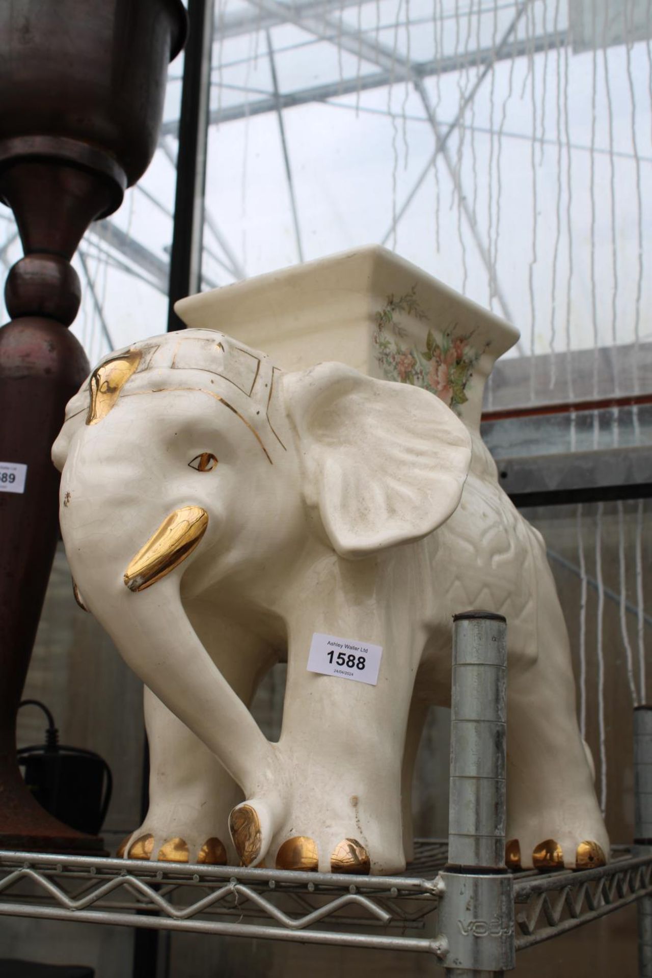 A DECORATIVE CERAMIC ELEPHANT JARDINAIRE STAND