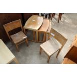 A RETRO TEAK NEST OF 3 TABLES AND A PAIR OF CHILDS STACKING CHAIRS