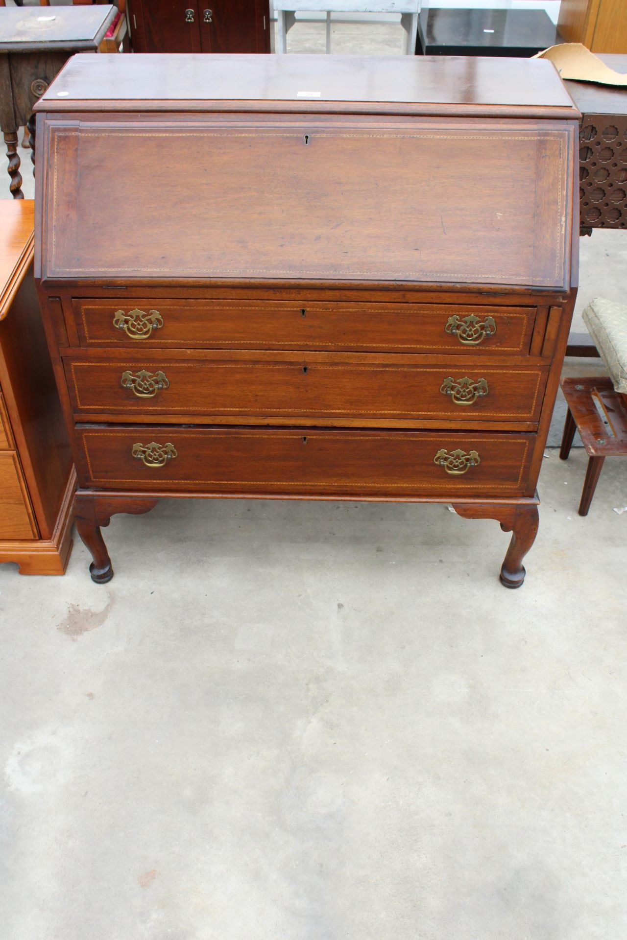 AN EDWARDIAN MAHOGANY AND INLAID BUREAU ON CABRIOLE LEGS, 36 INCHES WIDE