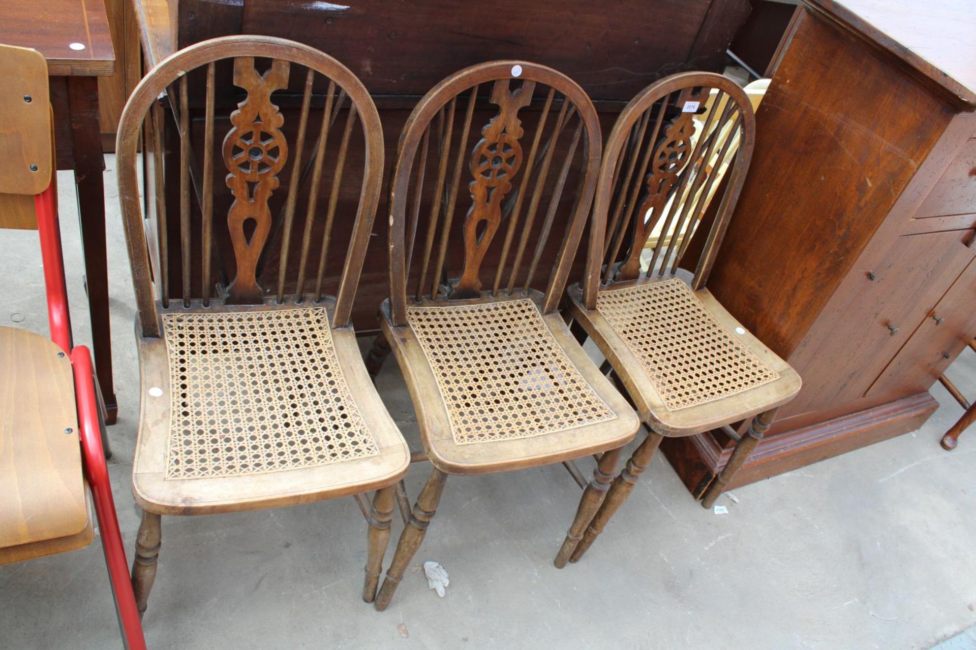 THREE WINDSOR STYLE WHEEL-BACK DINING CHAIRS WITH SPLIT CANE SEATS