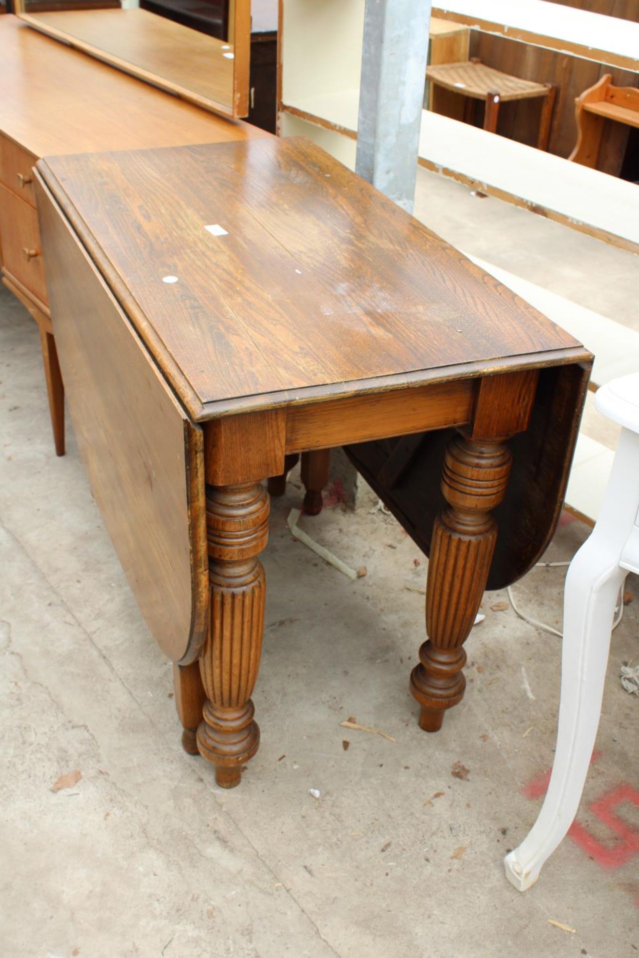 AN EARLY 20TH CENTURY OAK DROP-LEAF DINING TABLE ON TURNED AND FLUTED LEGS, 60" X 36" OPENED - Image 2 of 2