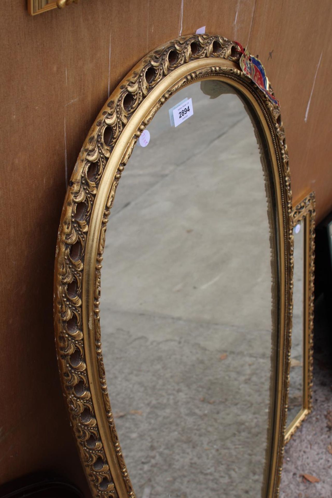A MODERN GILT FRAMED PERRY OVERMAN (GLOVE) WALL MIRROR, 48" X 21" - Image 2 of 2