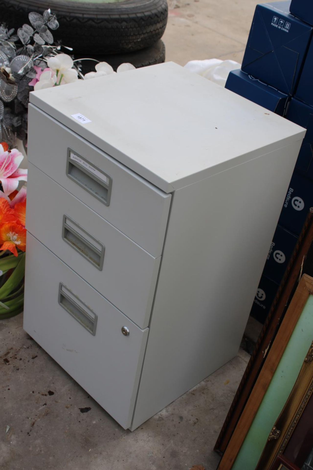 A THREE DRAWER METAL FILING CABINET