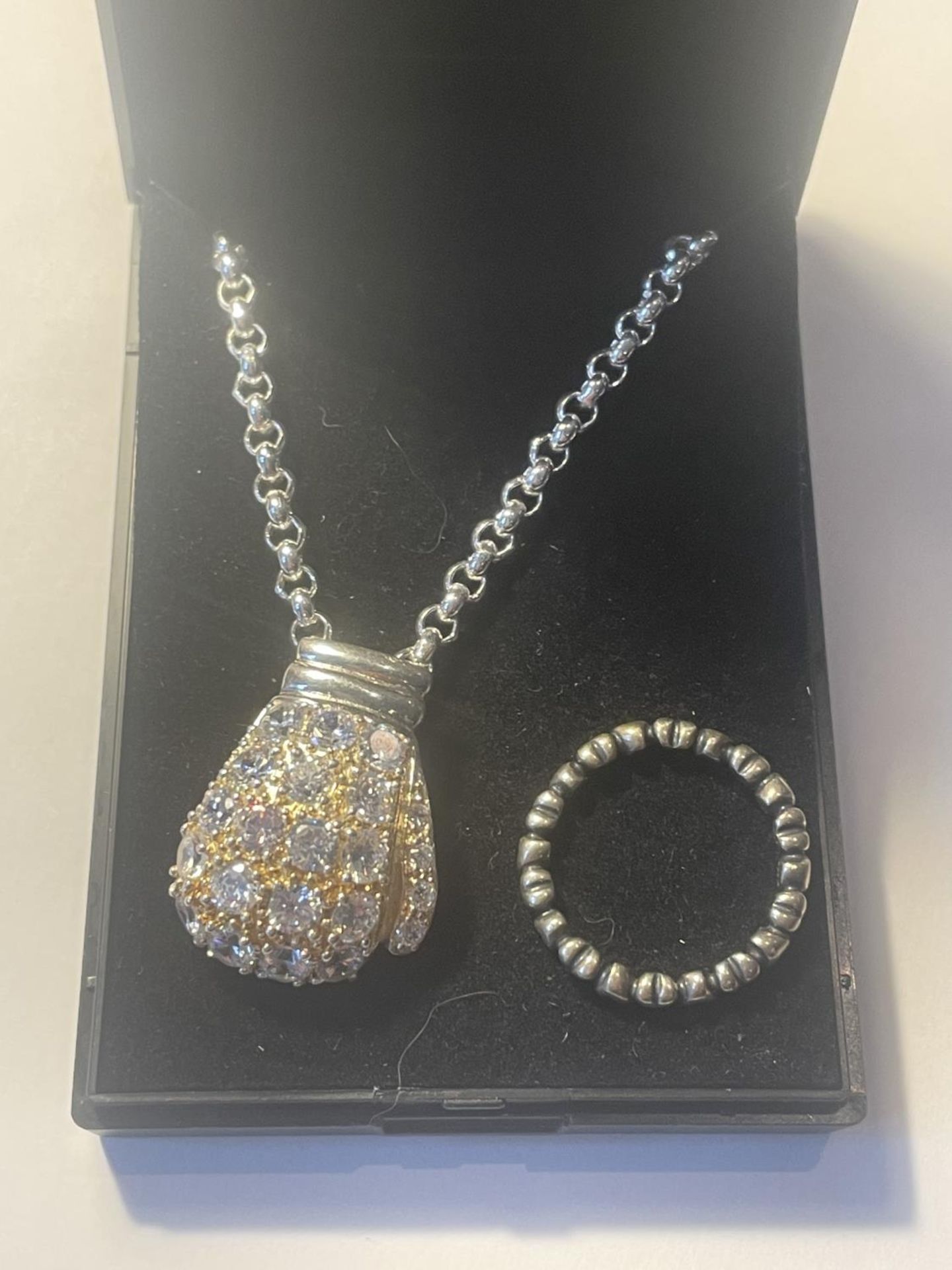 TWO MARKED SILVER ITEMS TO INCLUDE A CHAIN WITH CLEAR STONE BOXING GLOVE PENDANT AND A HEART