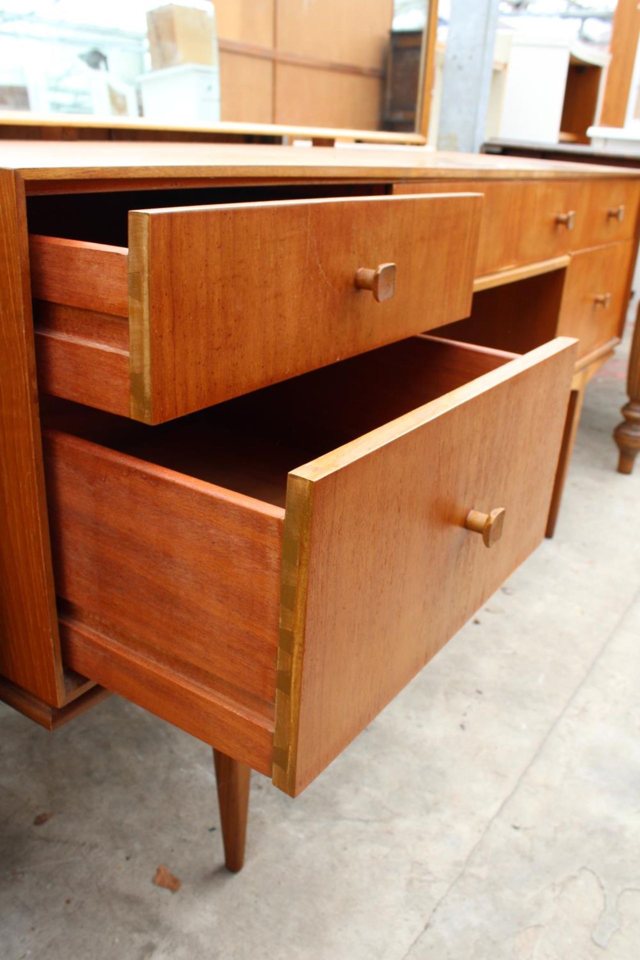 A MCINTOSH RETRO TEAK DRESSING TABLE ENCLOSING FIVE DRAWERS, 55.5" WIDE ON TAPERING LEGS - Image 4 of 4