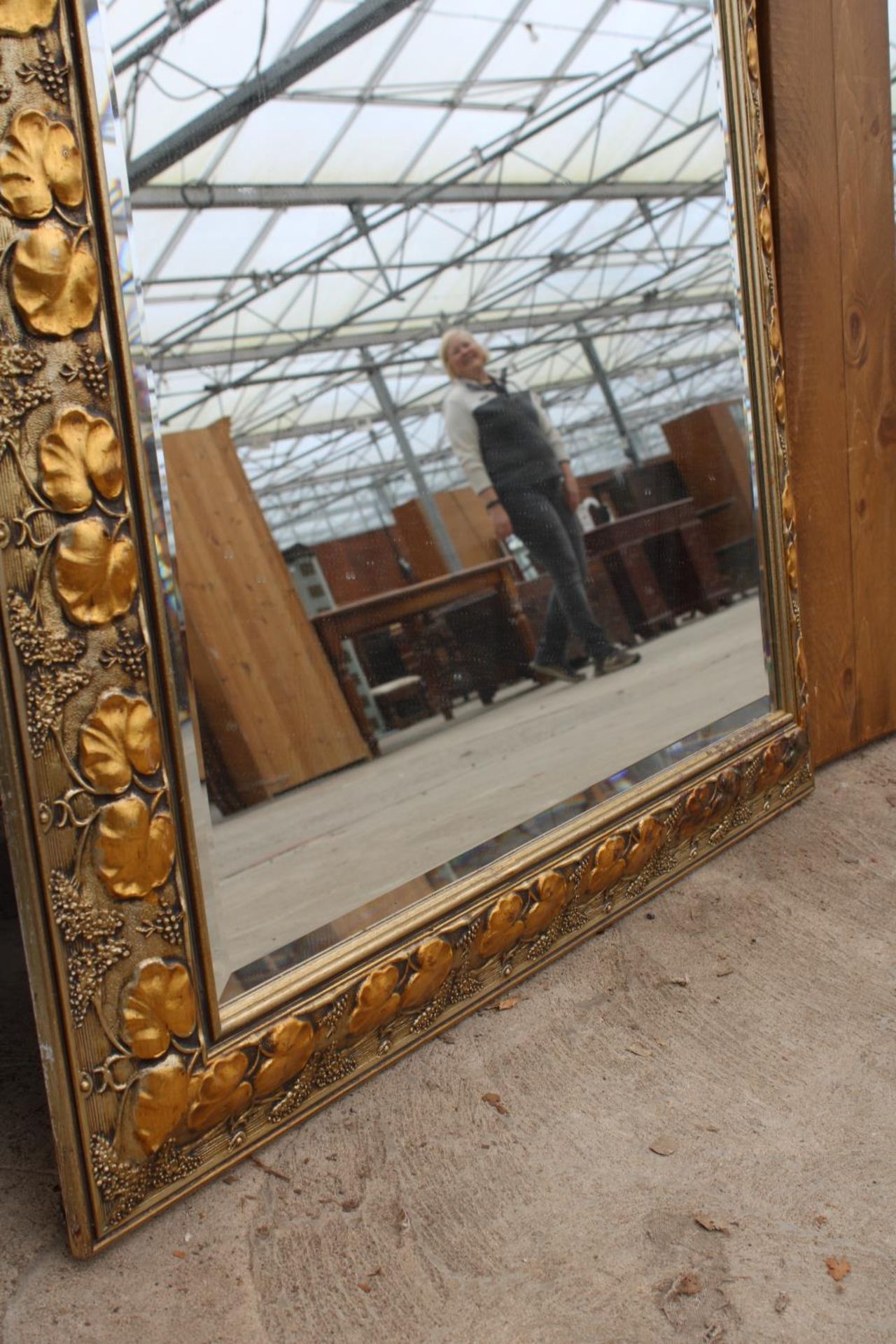 A MODERN GILT FRAMED WALL MIRROR WITH BEVEL EDGE AND FOLIATE DECORATION, 48" X 37" - Image 3 of 3