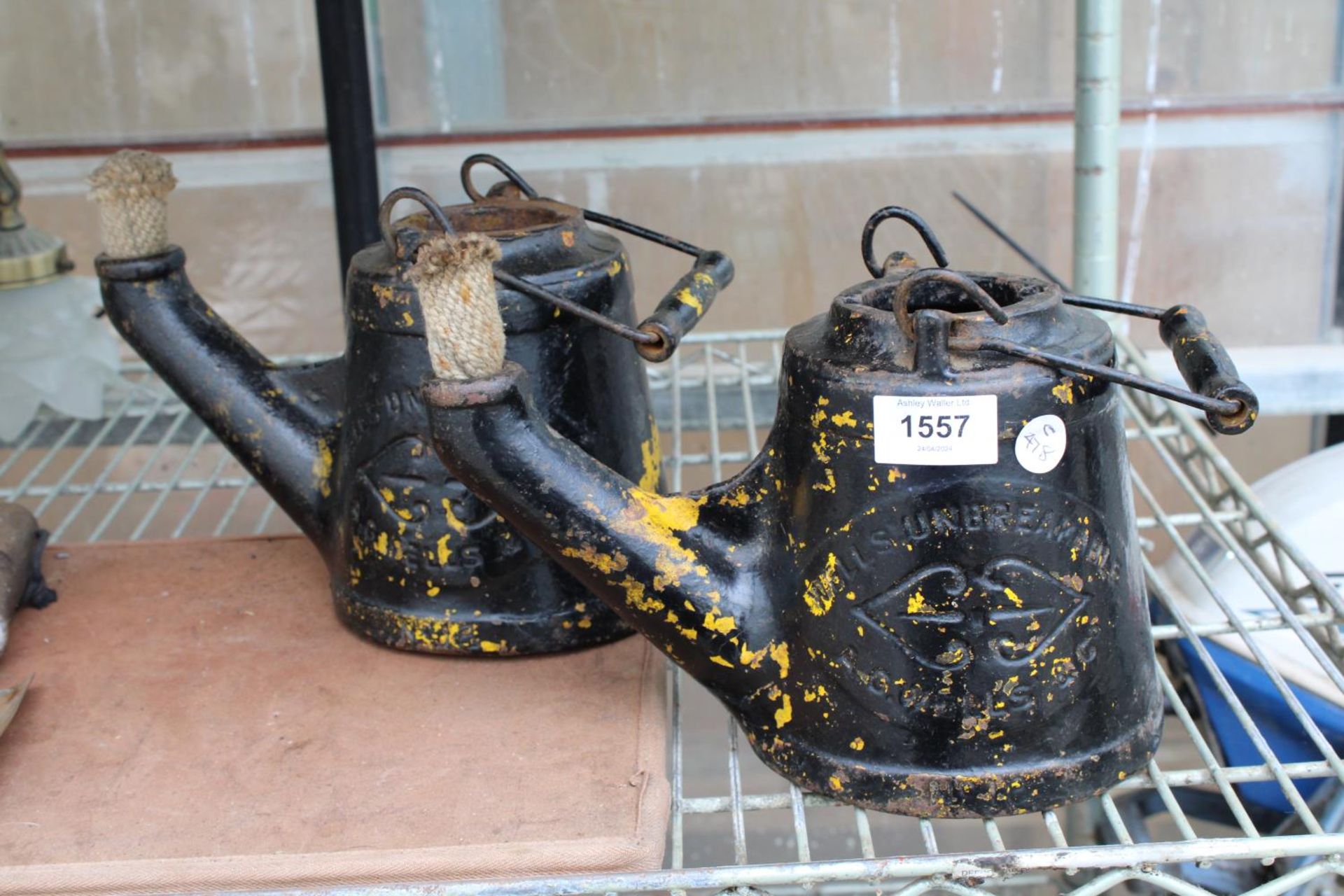 A PAIR OF VINTAGE CAST IRON PARAFIN BURNING KETTLES