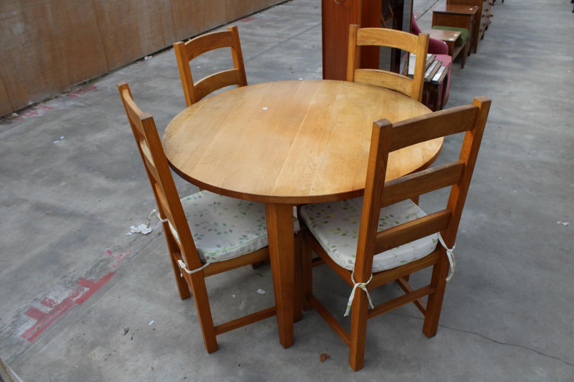 A CIRCULAR OAK DINING TABLE, WITH FOUR OAK LADDER BACK DINING CHAIRS WITH RUSH SEATS, DIAMETER 111CM