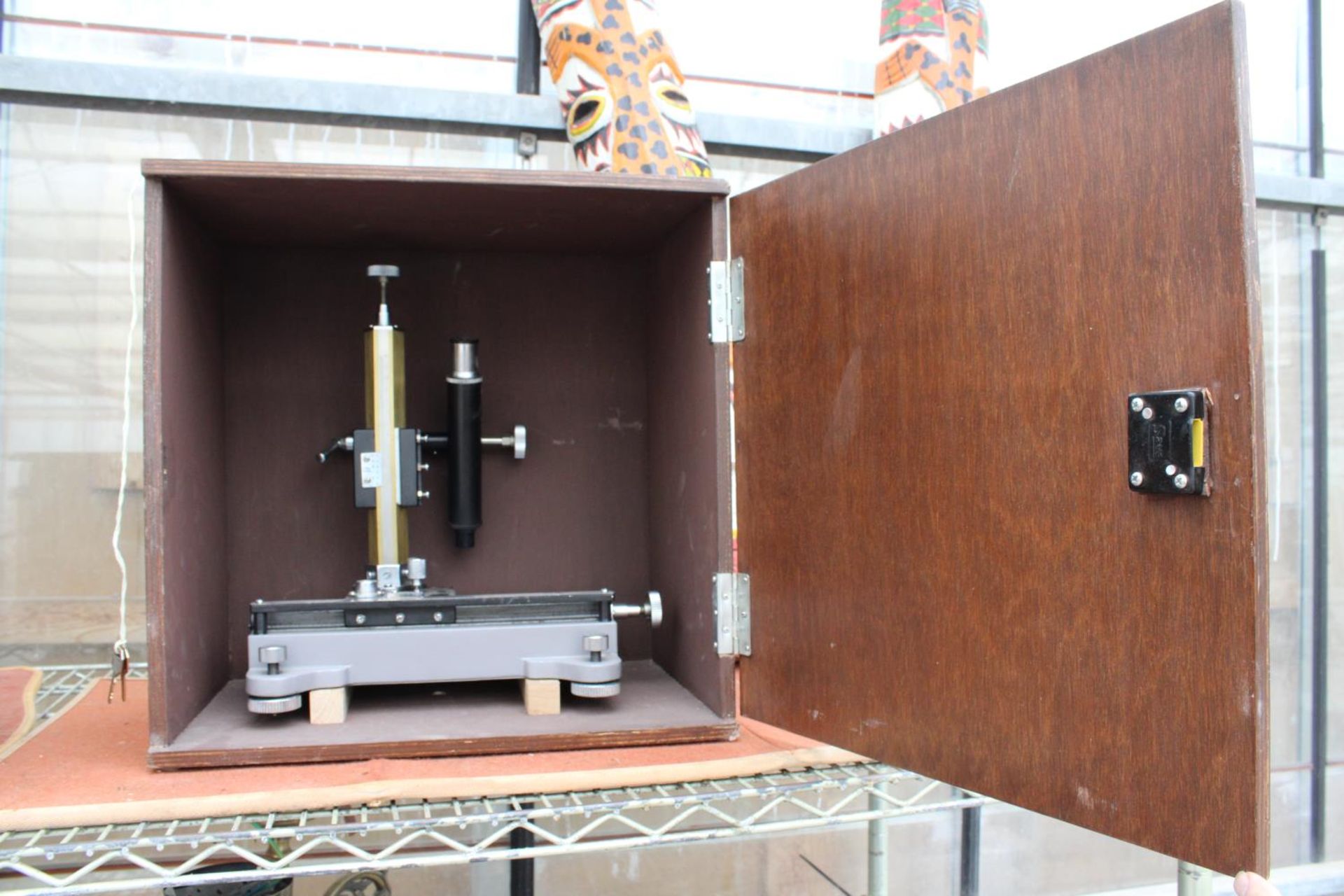A CASED ACADEMICAL MICROSCOPE COMPLETE WITH KEY FOR CASE