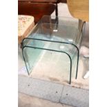 A NEST OF TWO GLASS TABLES