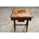 A VICTORIAN WALNUT SEWING TABLE WITH SLIDING TOP ENCLOSING 8 LIDDED COMPARTMENTS, ON BARLEY-TWIST