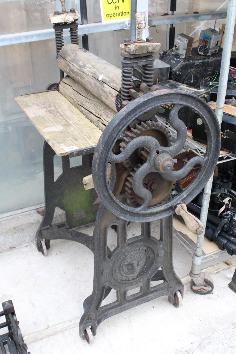 A VINTAGE CAST IRON AND WOODEN MANGLE BEARING THE NAME 'THE HERO MACHINE'